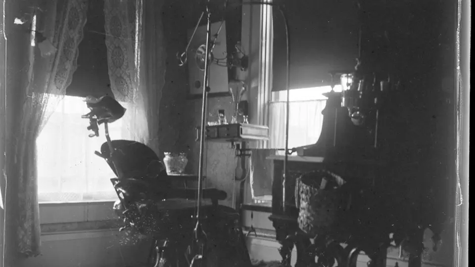 An empty dental operatory with chair and light