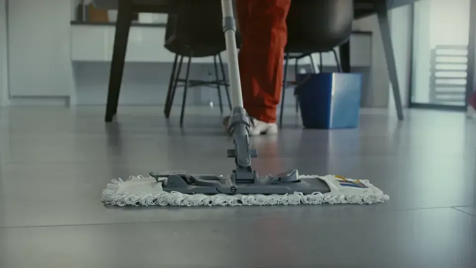 A mop working a wet hard floor